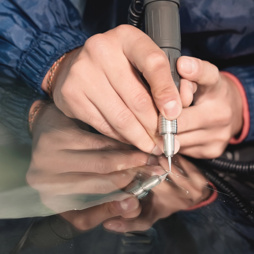 A man repairing a windshield