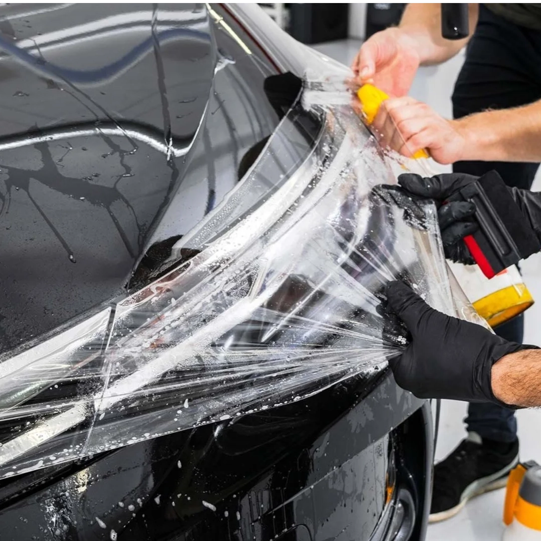 Technicians installing paint protection film