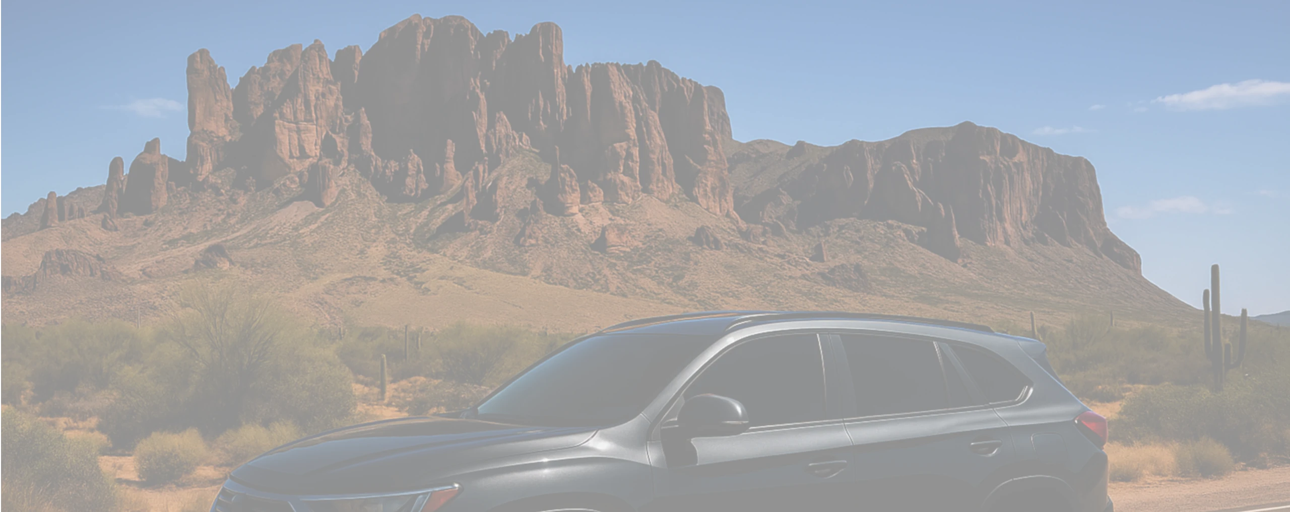 a car next to a mountain