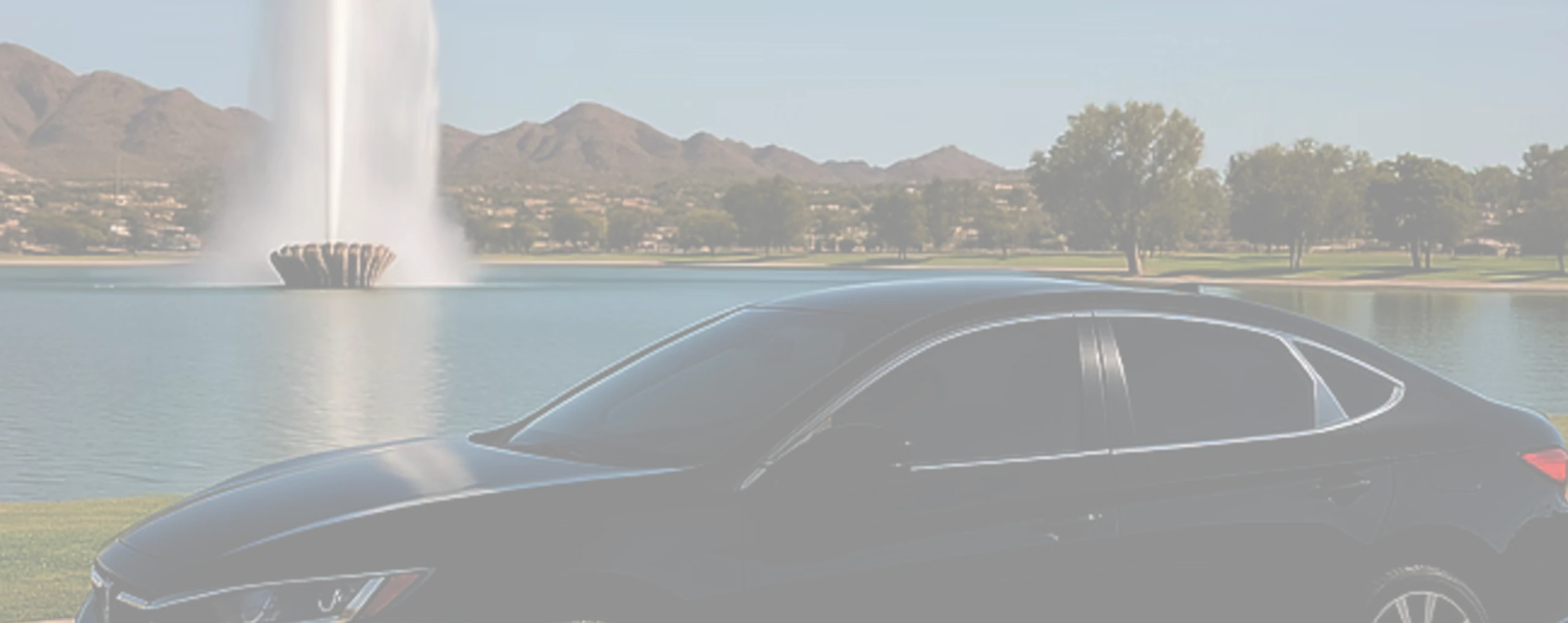 a car with window tint next to a fountain