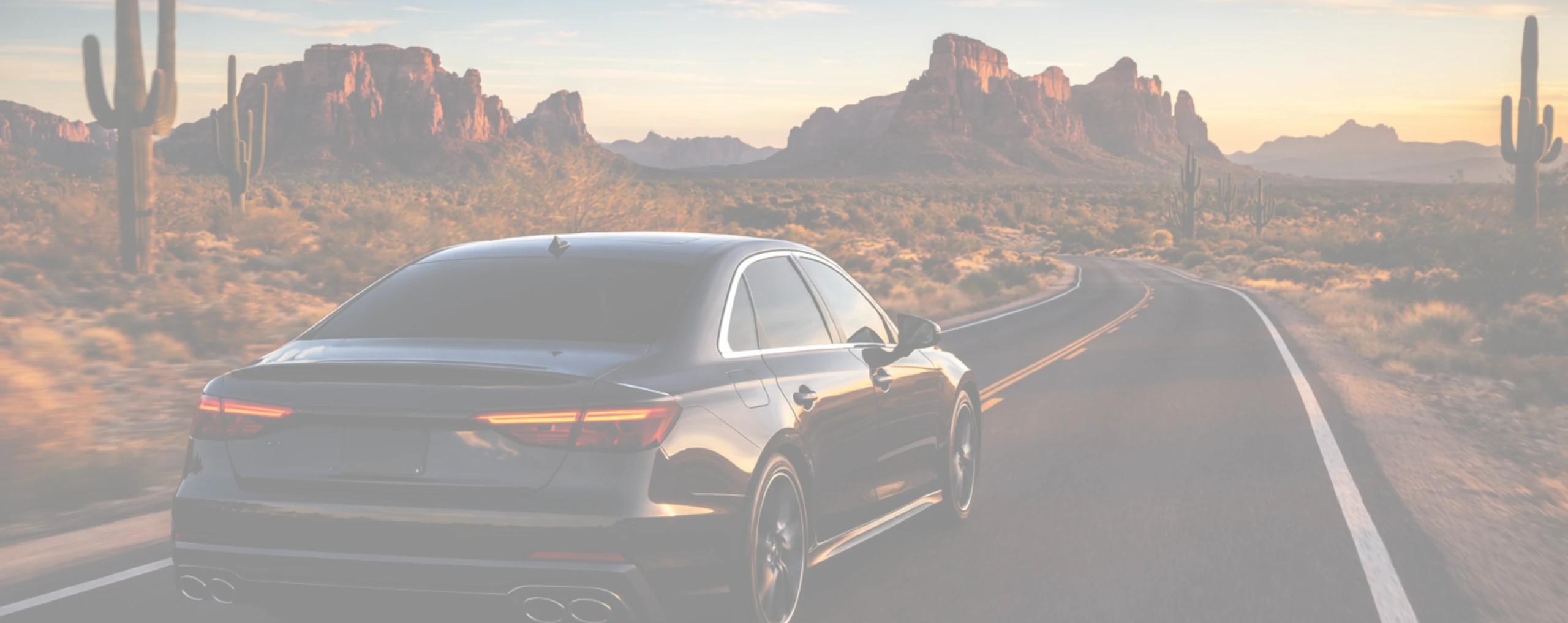 a luxury vehicle with auto window tint driving through arizona