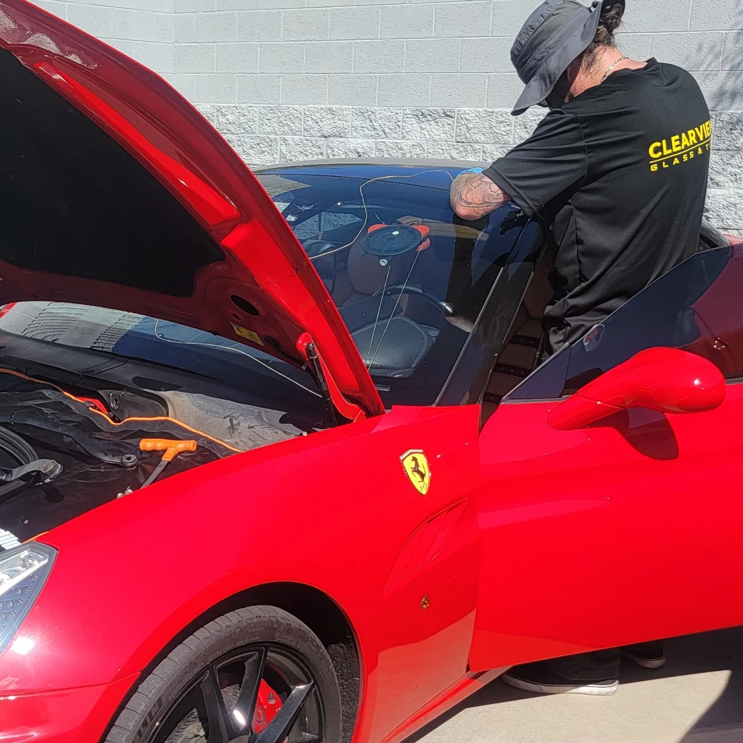 a technician replacing a windshield for a client in mesa arizona
