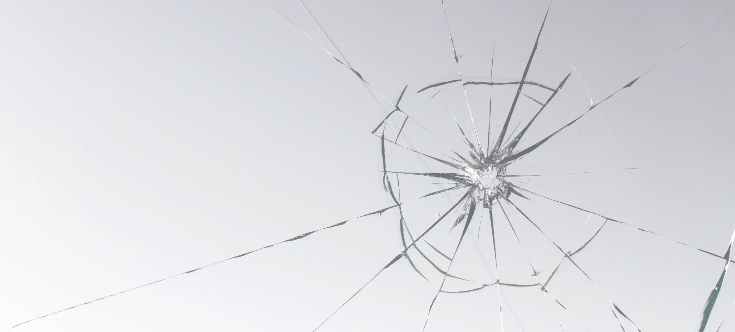 a cracked windshield with a small chip