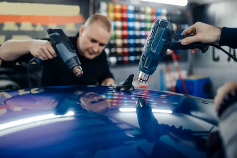 Vinyl Wraps a technician applying a vinyl wrap to a car